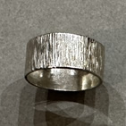 Wide silver ring with vertical markings